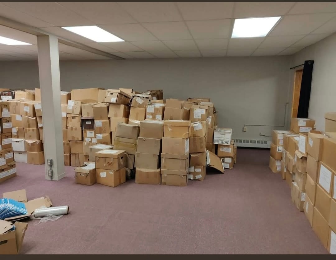 Large room filled with labelled cardboard boxes ready for a commercial relocation