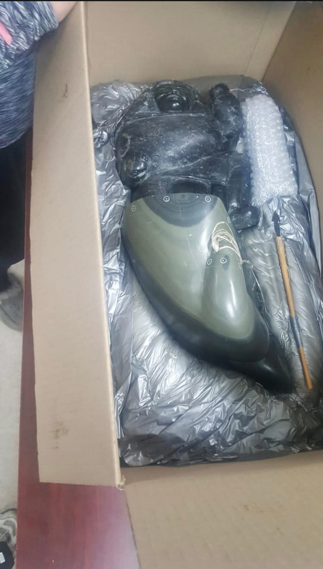 Inuit stone carving carefully packed in a cardboard box with protective wrapping